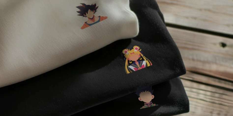 Stack of black and white sweatshirts from the Anime Minis collection by inspire.inc