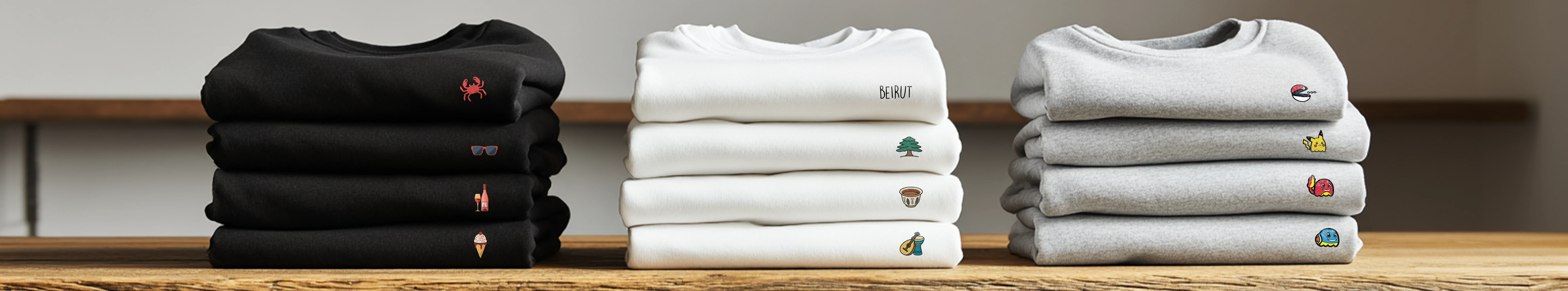 Stacks of black, white and gray sweatshirt with Mini designs on them by inspire.inc