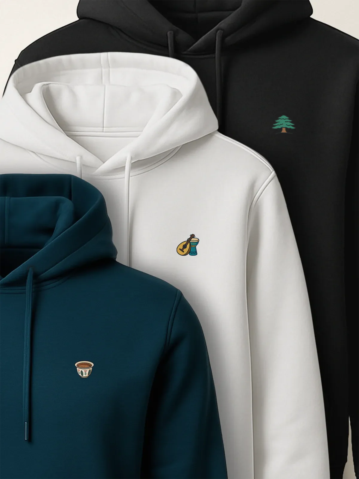 Black, white and blue hoodies with the Cedar, Music Duo and Lebanese Coffee designs for the Lebanon Minis collection by inspire.inc