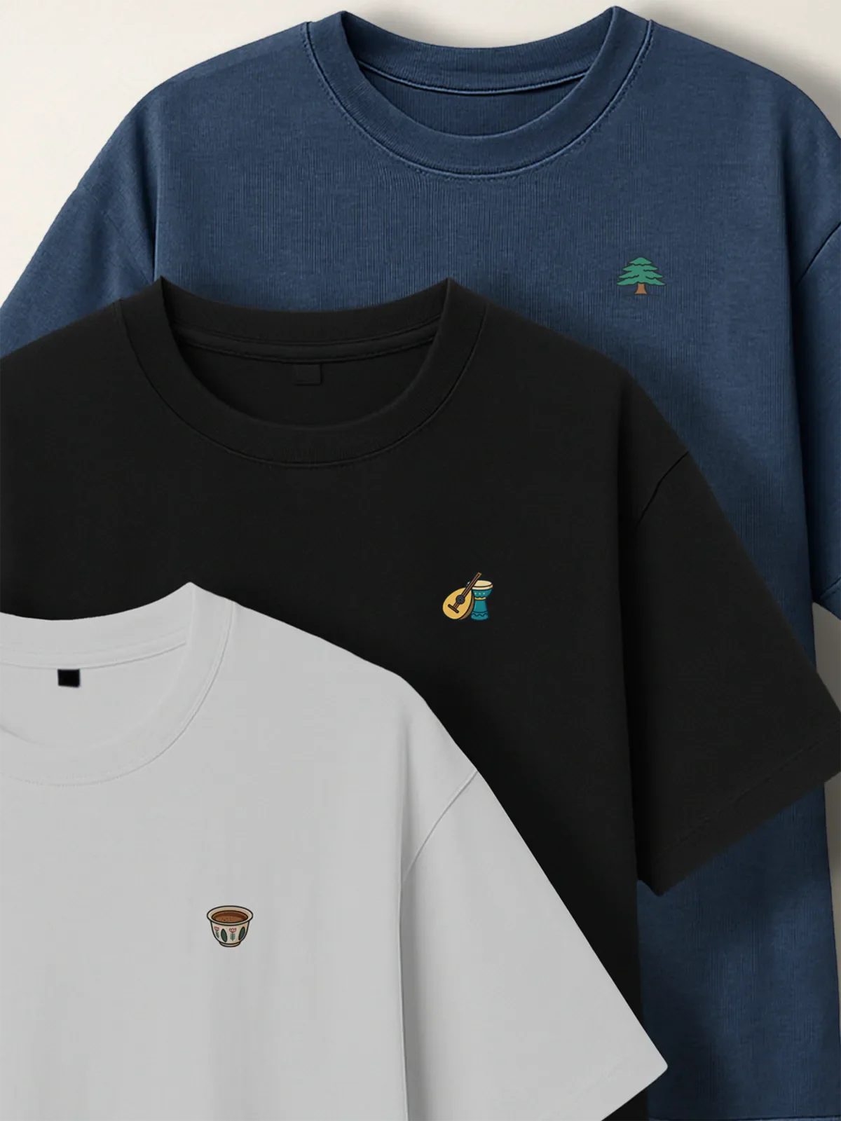 Blue, black and white t-shirts with the Cedar, Music Duo and Lebanese Coffee designs for the Lebanon Minis collection by inspire.inc