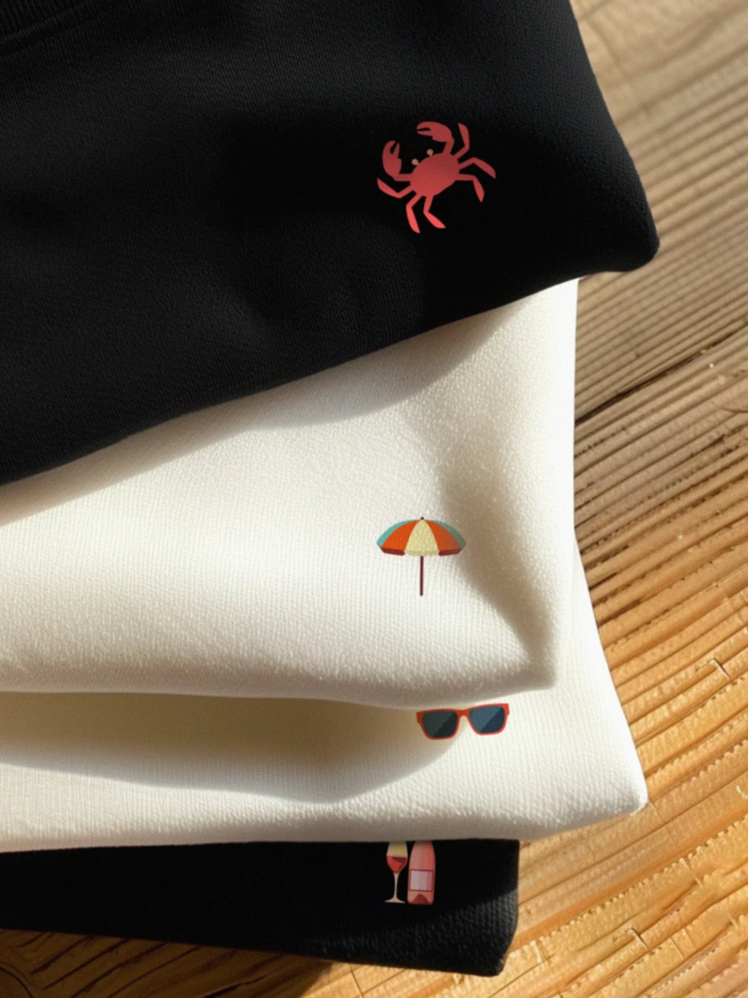 Stack of 2 black and 2 white t-shirts with Mini designs for the Summer Minis collection by inspire.inc