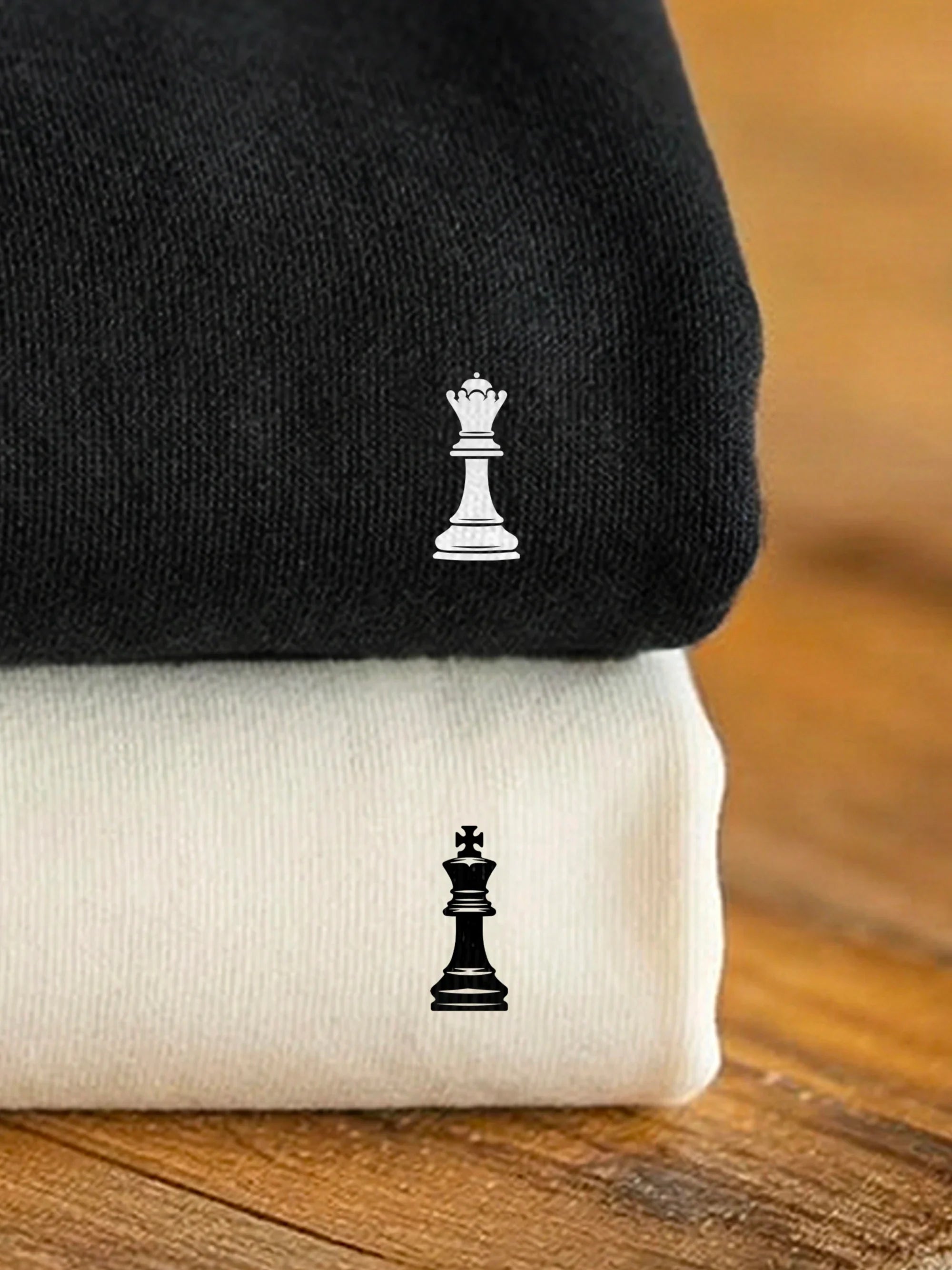 Stacked black and off white sweatshirts with designs from the Perfect Match - Check Mates collection by inspire.inc