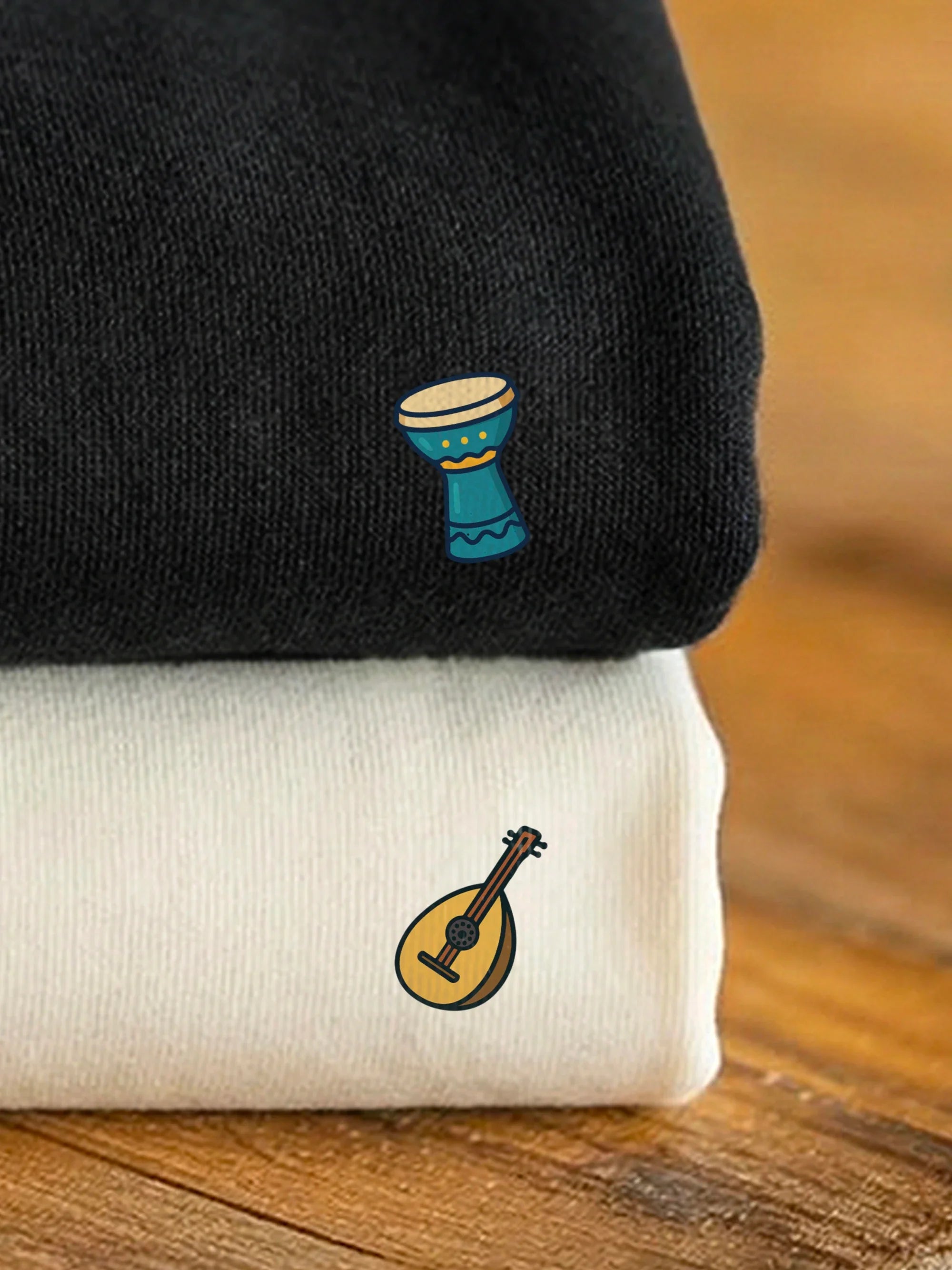 Stacked black and off white sweatshirts with designs from the Perfect Match - Music Duo collection by inspire.inc