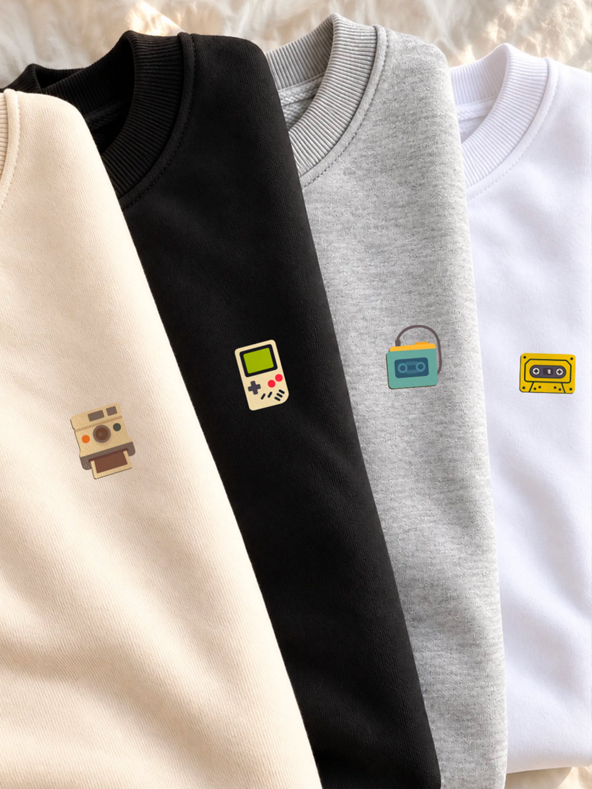 Stack of sweatshirts from the Retro Minis collection by inspire.inc